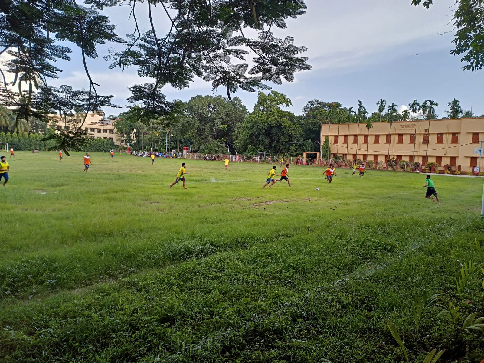 Students match in West Bengal, India — players and ball visible