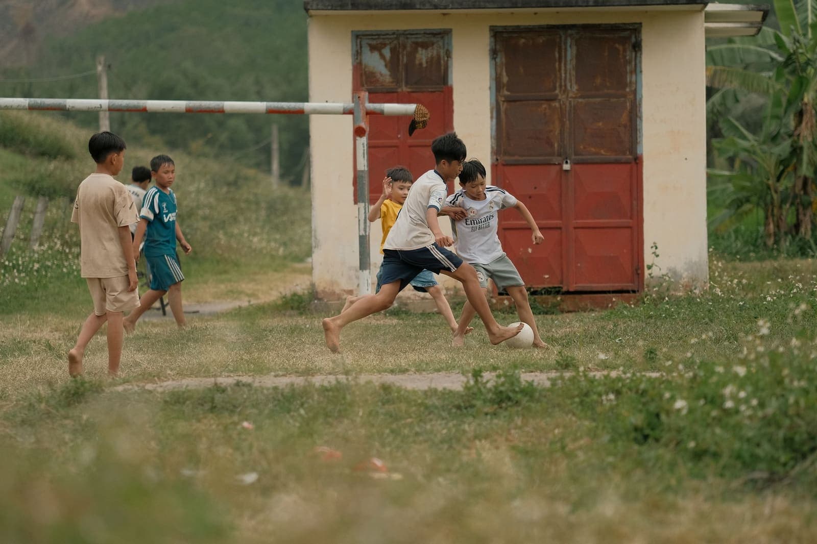 Children playing football on rural Indian field