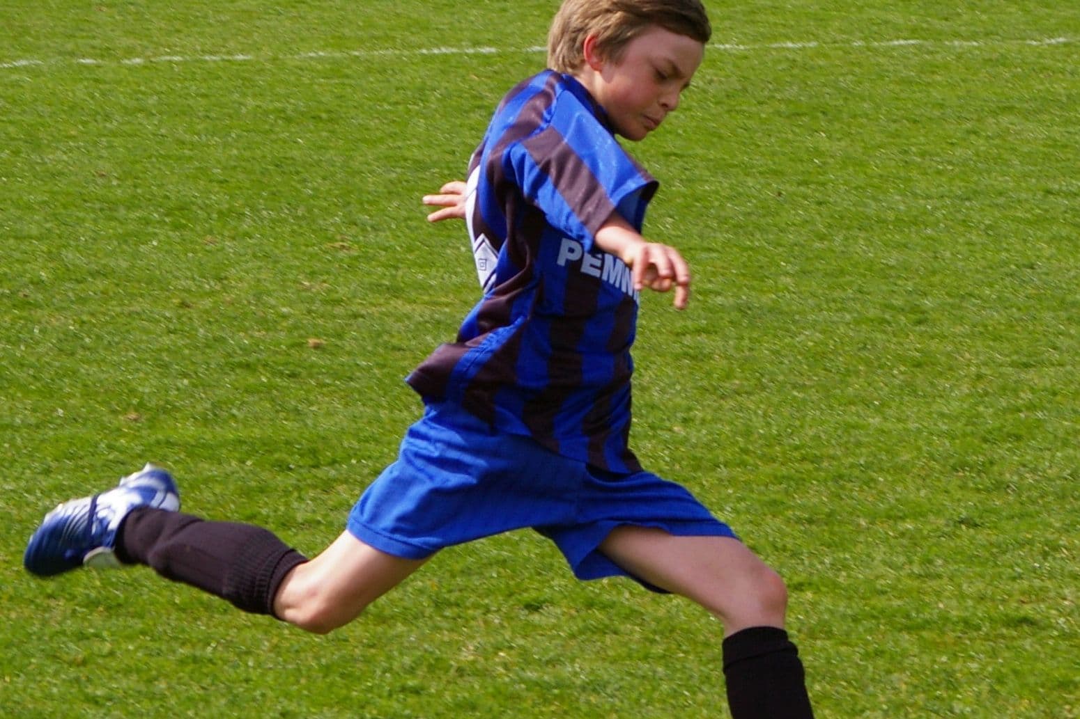 U11 youth football players on pitch
