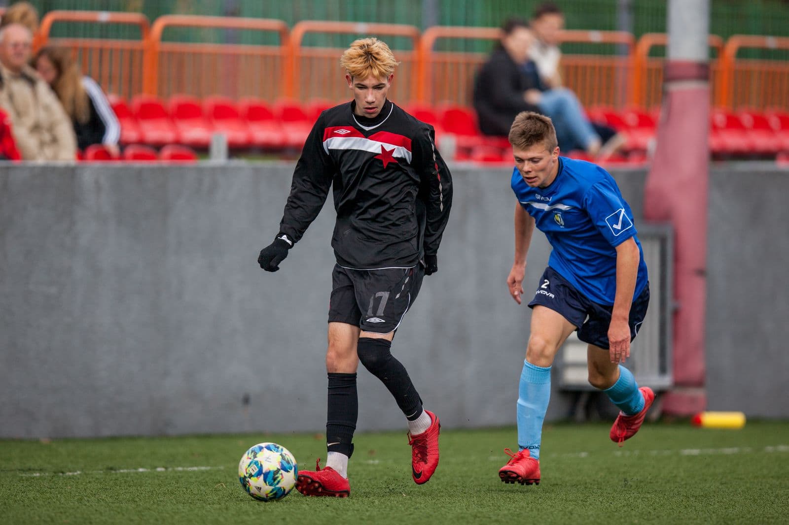 Youth football game with players contesting the ball