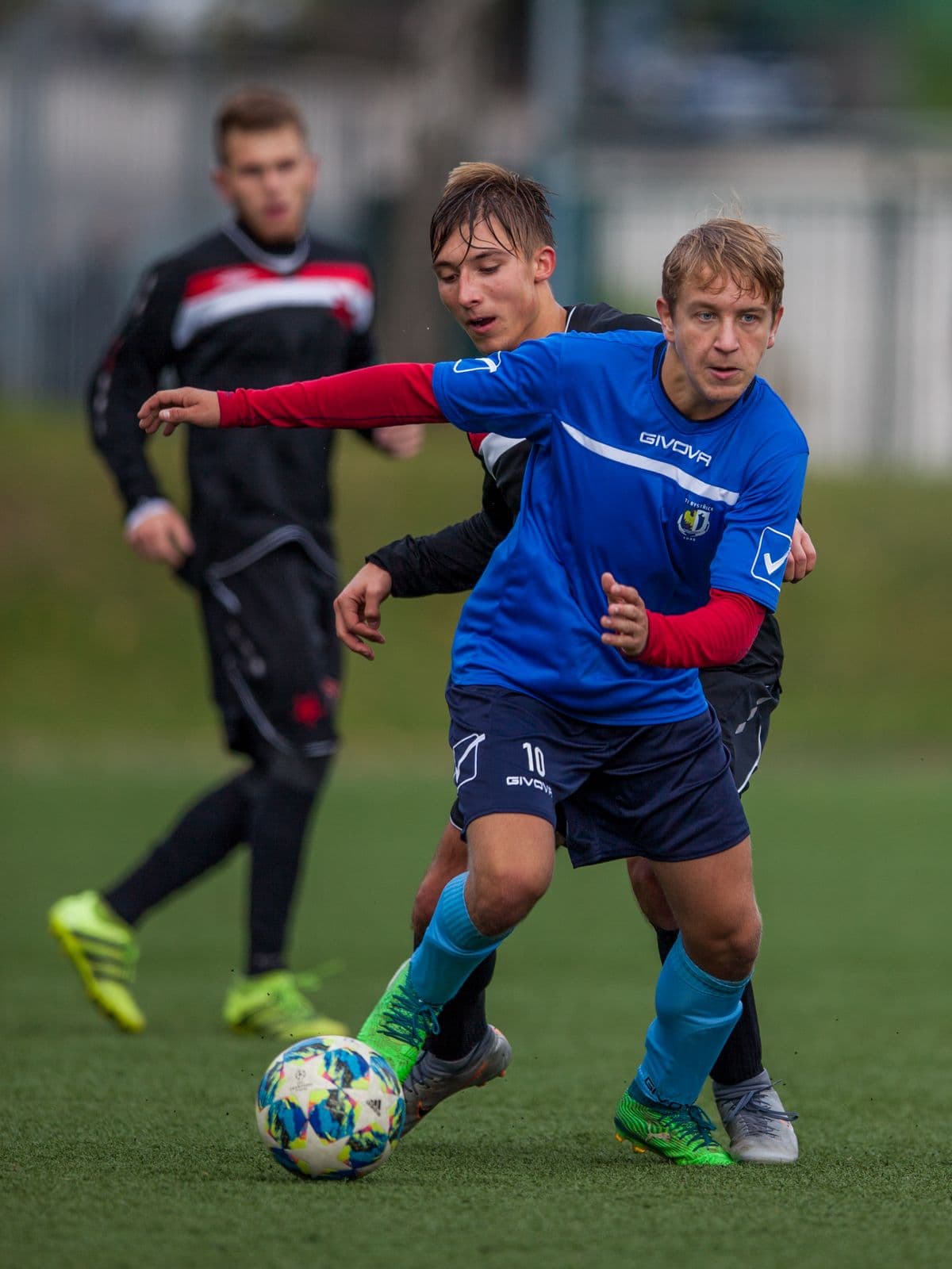 Youth footballer dribbling the ball during a match