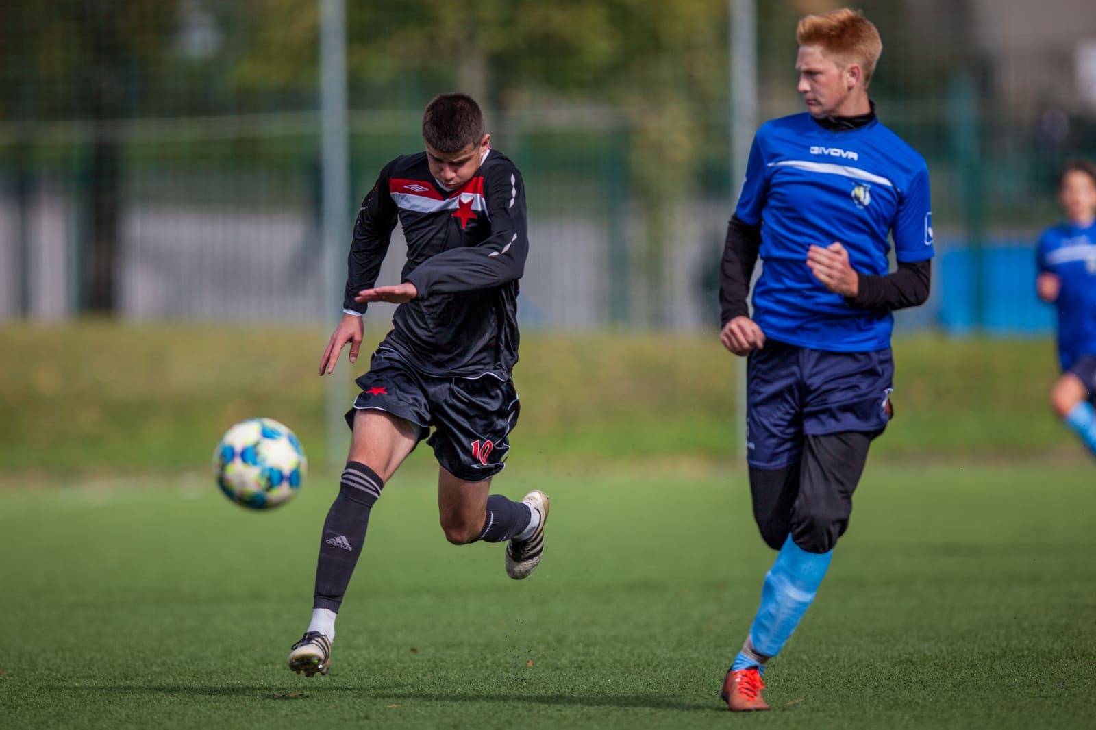 Youth footballer passing the ball during a match