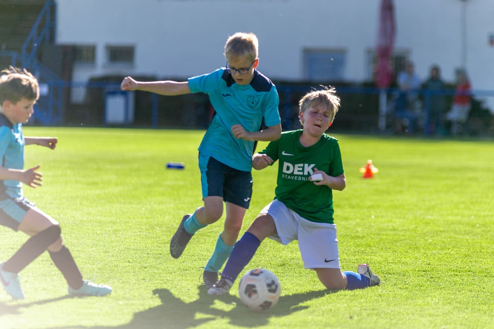 Young footballer sliding to win the ball during a youth match